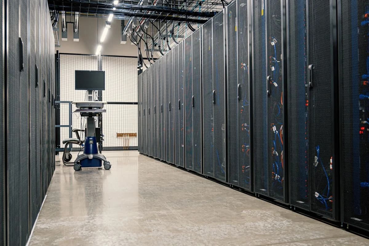 Rows of server racks and cabling in a school IT data room
