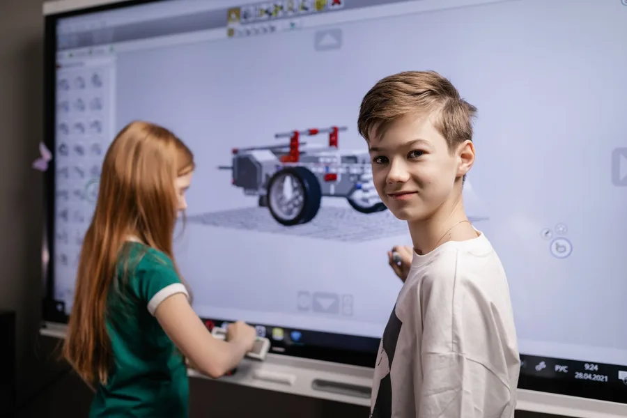 Students using an interactive display in a classroom